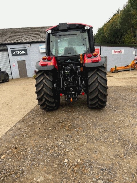 A McCormick X5.120 tractor parked at the workshop doors